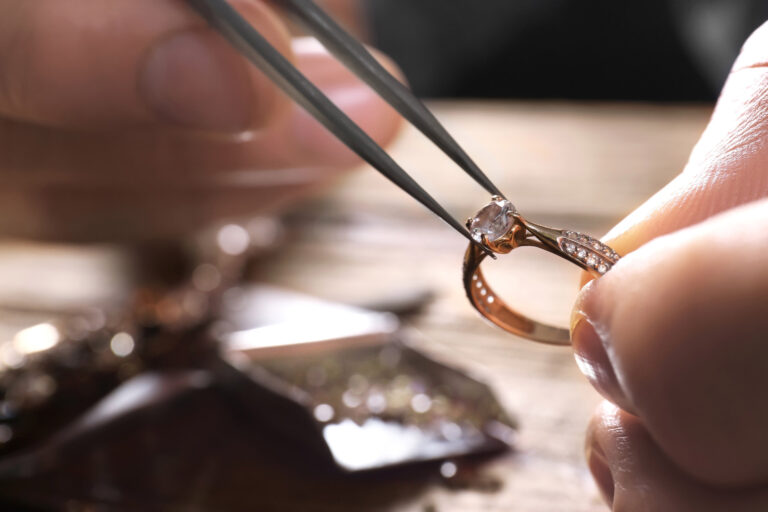 someone adjusting a diamond in a ring, representing high value jewellery insurance