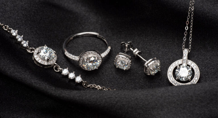 silver jewellery on a black cloth, representing private client insurance