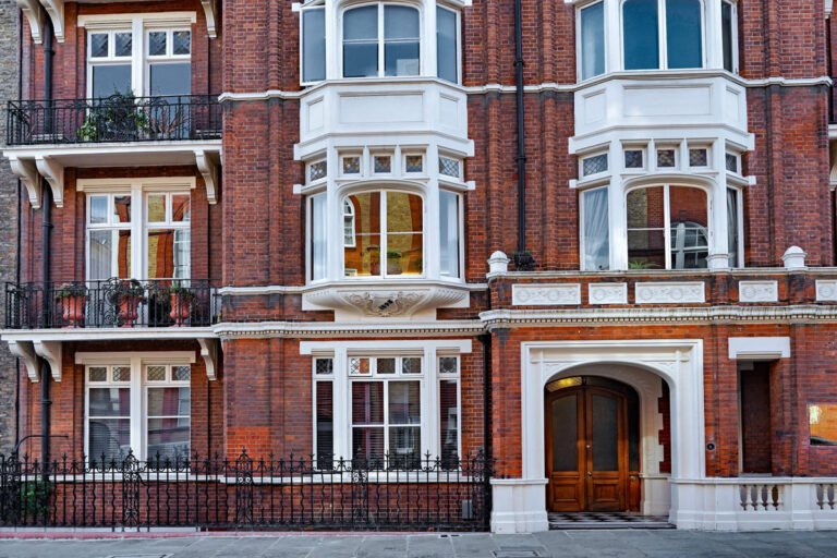 a large red brick building, representing private client insurance